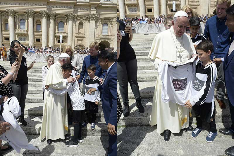 Pope Francis hugs youth members of TUFF